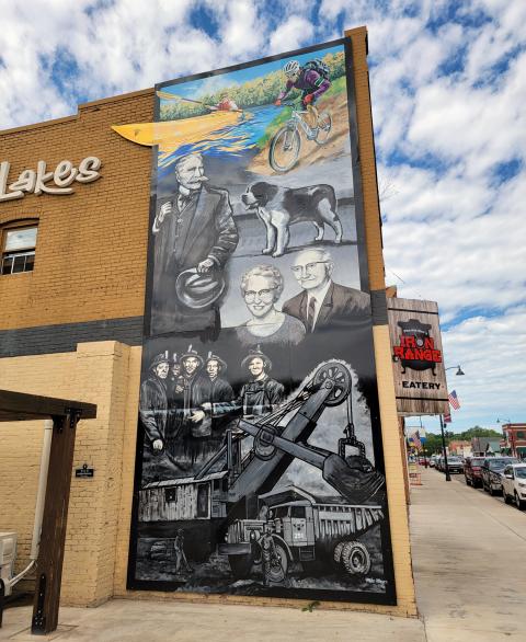 Mural on side of building depicting hsitory of Cuyuna area