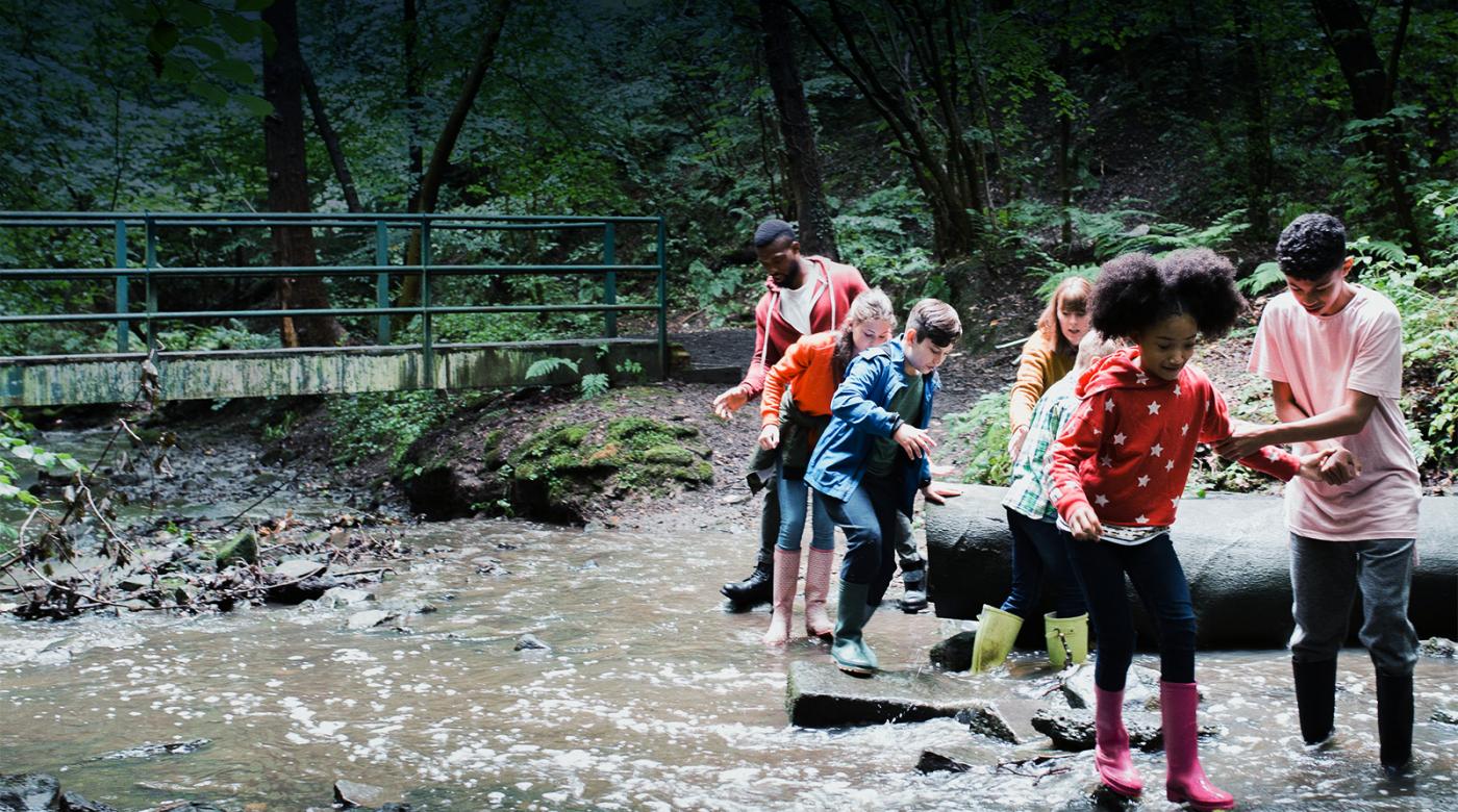 kids crossing stream on field trip
