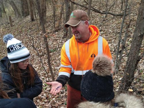Students learn about invasive species in the forest