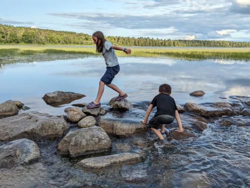 Kids play on rocks at Mississippi headwaters