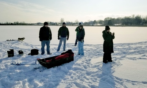 Four people on a frozen lake