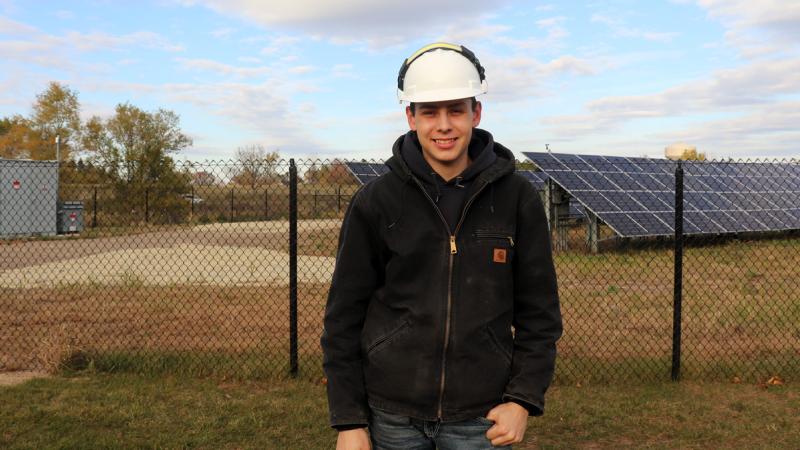 Micah Rivera near solar panels