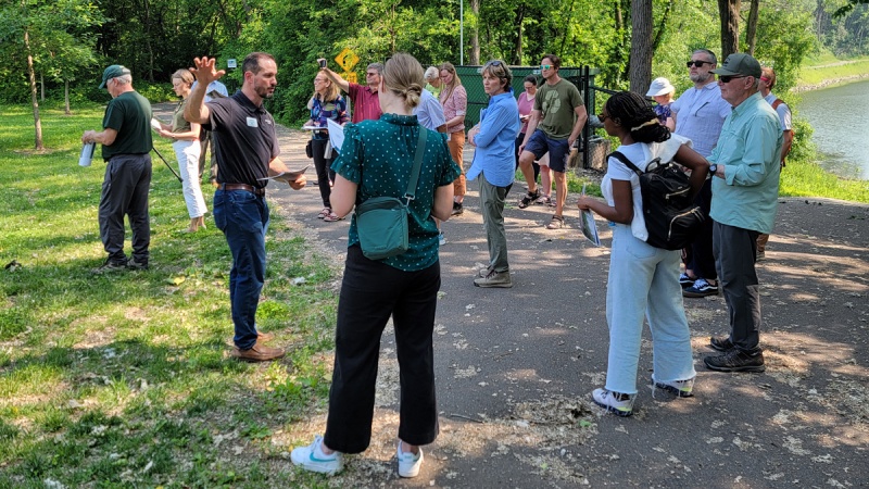 Group gathers at water's edge to listen to guide