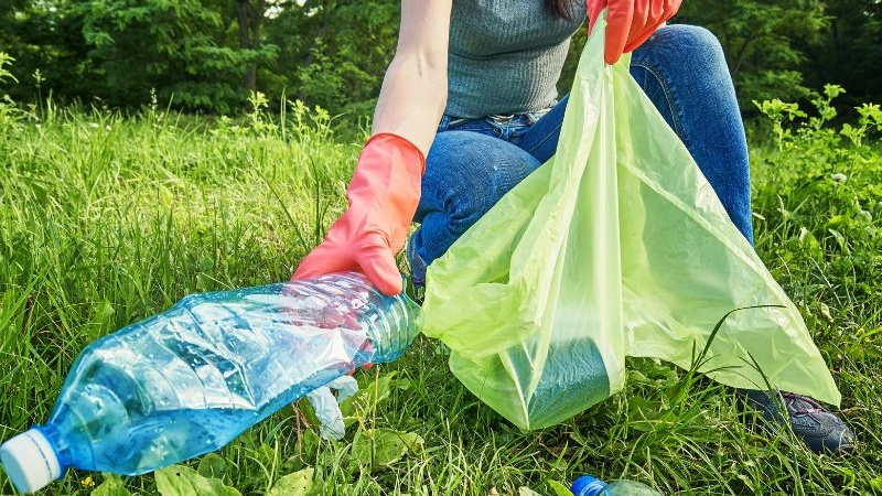 person picking up litter