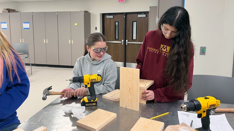 Students construct a wood birdhouse