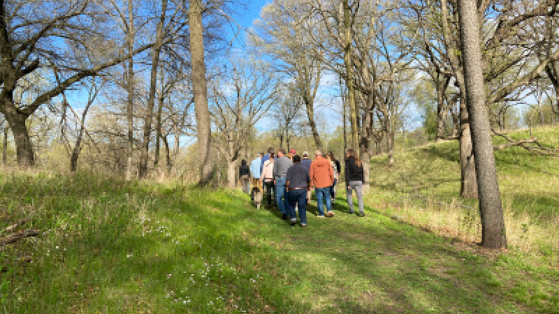 group of people walking on a path outside in the spring