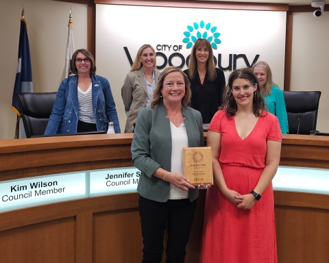 Group poses with award