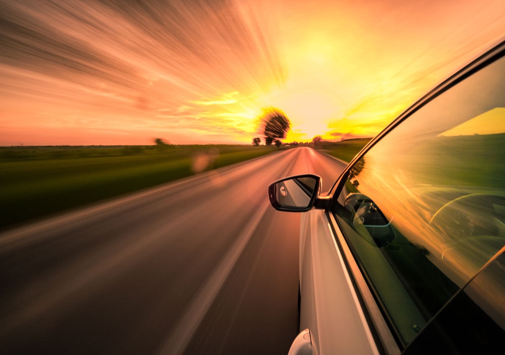 car on road at sunset