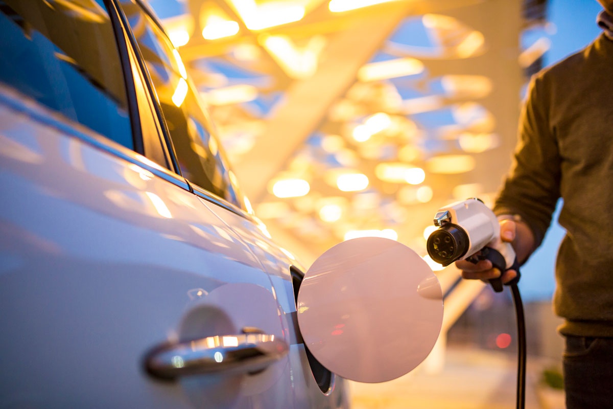 person at an electric vehicle charging station 