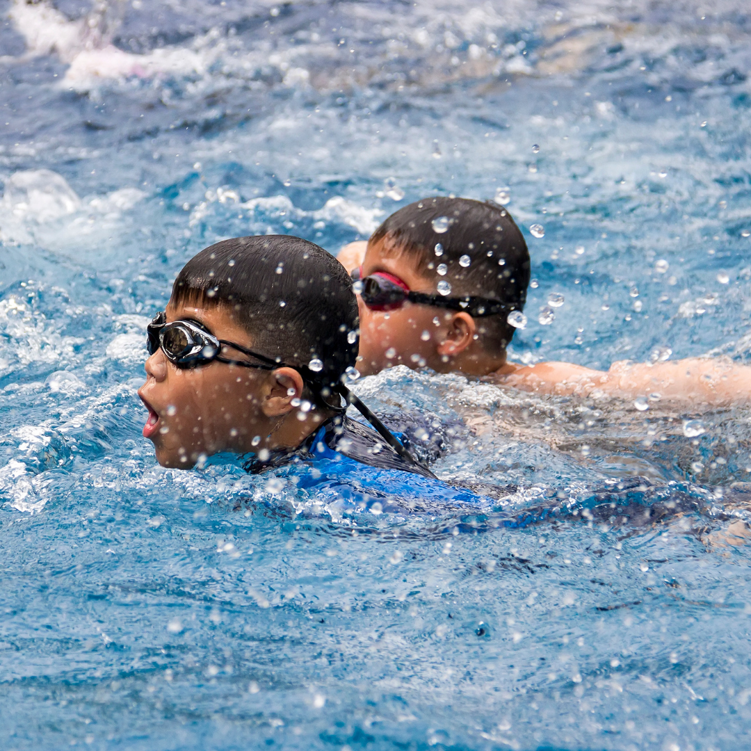 Two boys swimming in pool