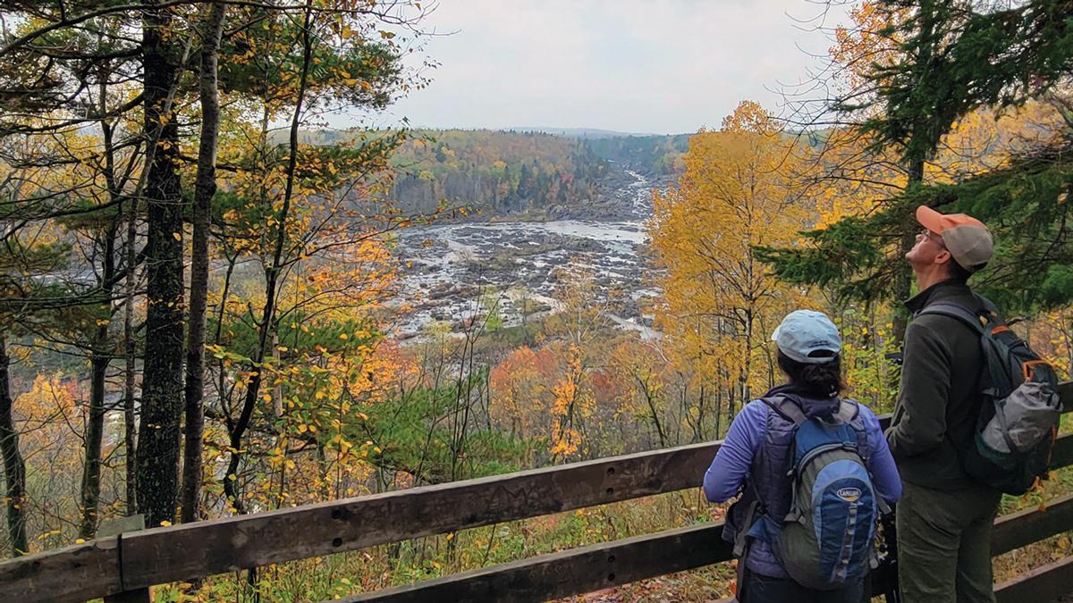 Hikers enjoy fall colors at at overlook