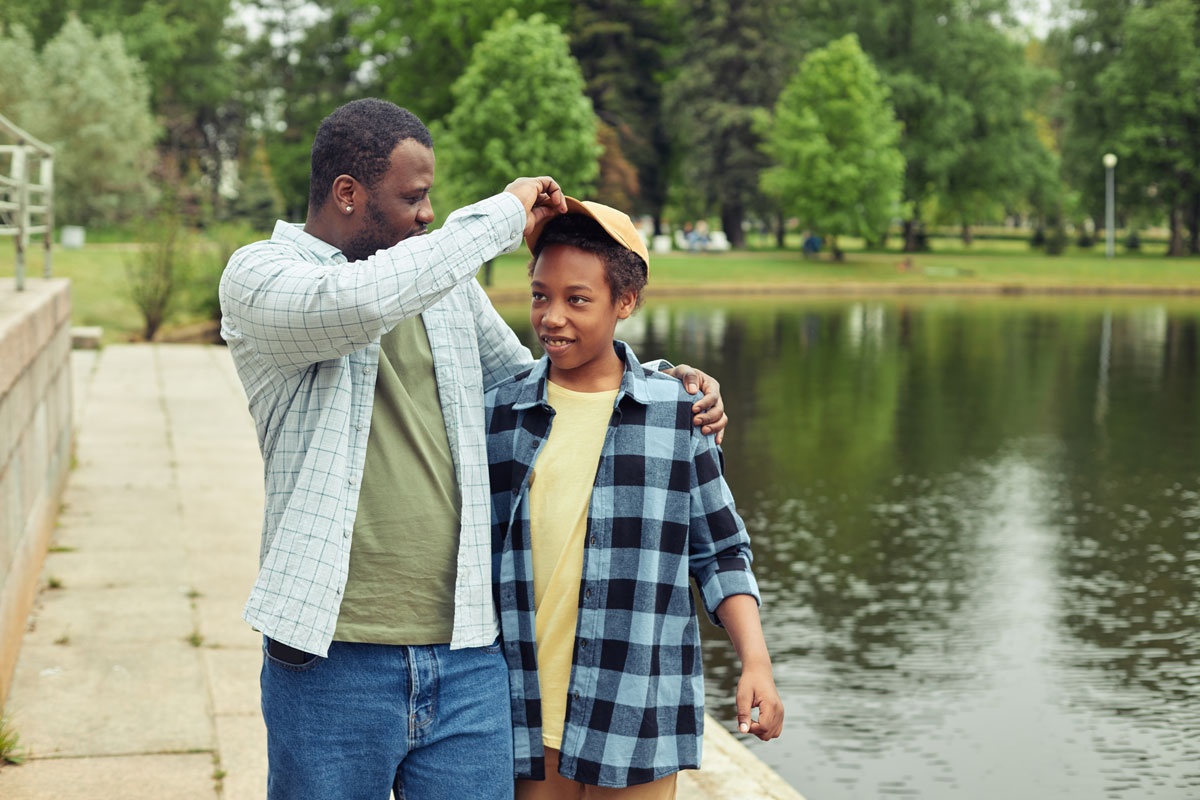 Dad and son enjoy summer by the lake