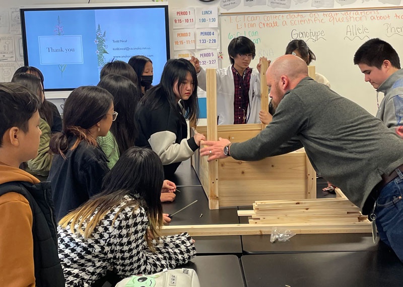 Students learn how to make a wood garden bed