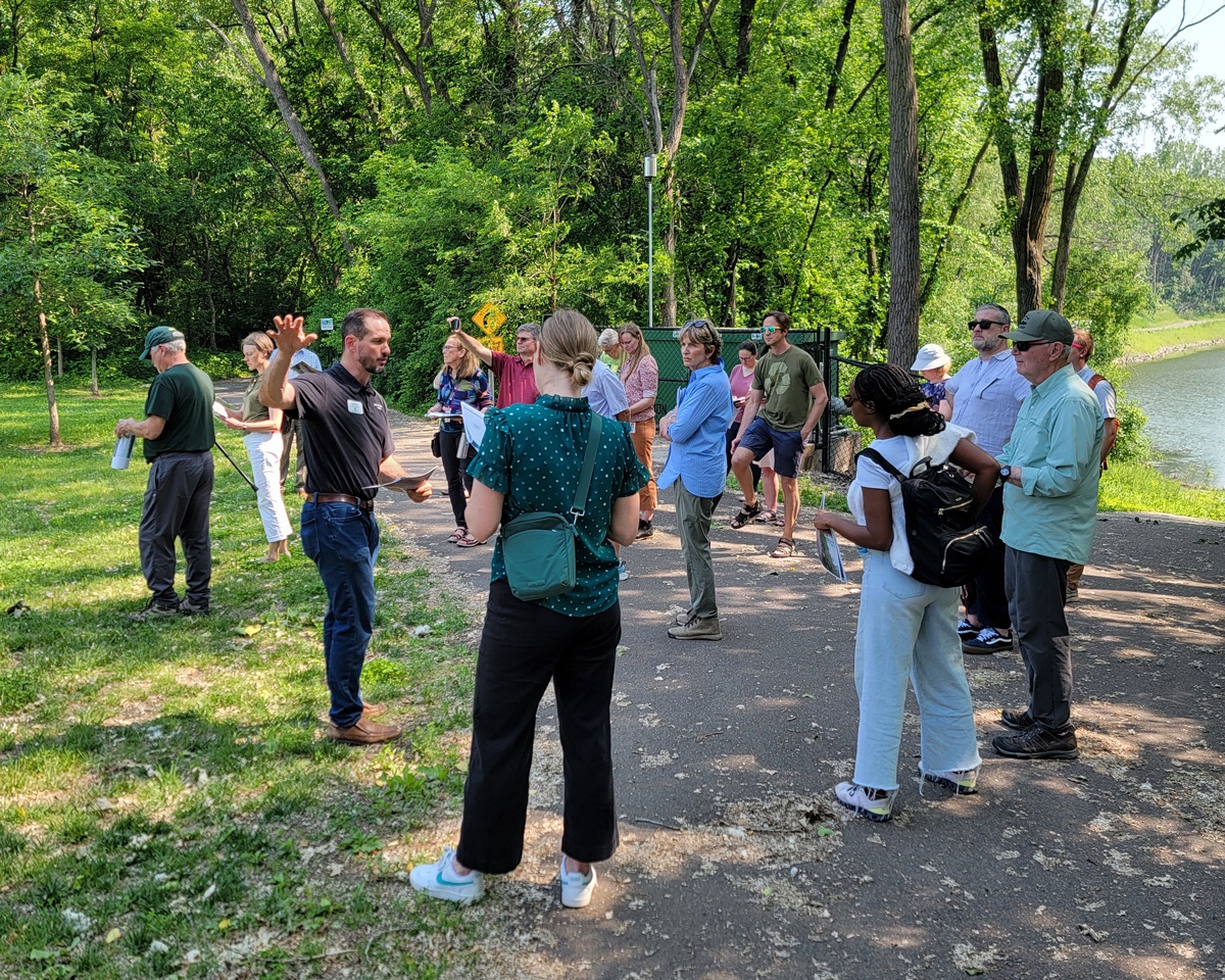 Group gathers at water's edge to listen to guide