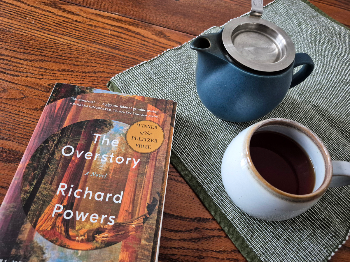 Book and tea, ready to read. The overstory by Richard Powers.