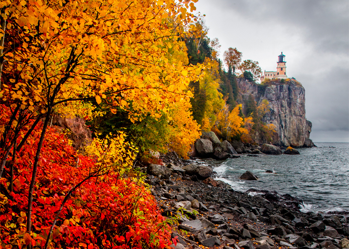 Split Rock Lighthouse in the distance overlooks Lake Superior in the fall