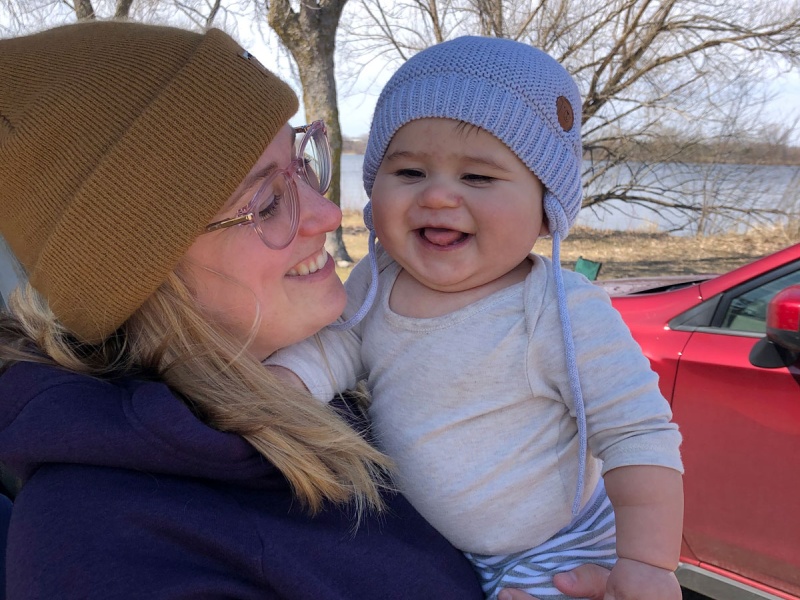 Mom holds infant son outside