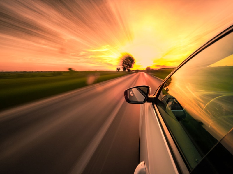 car on road at sunset