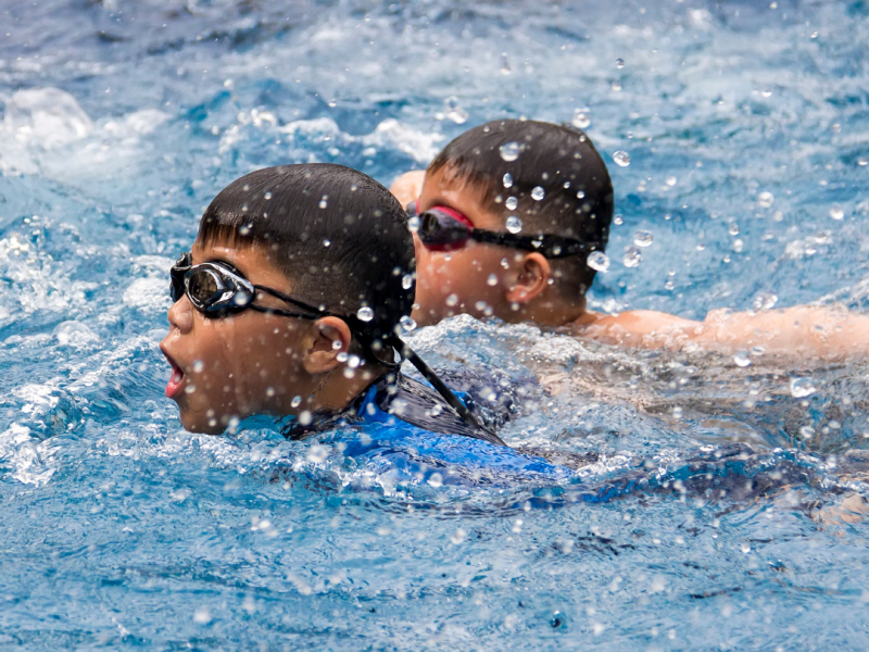 Two boys swimming in pool