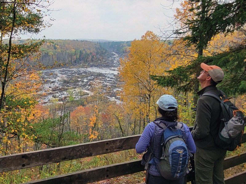 Hikers enjoy fall colors at at overlook