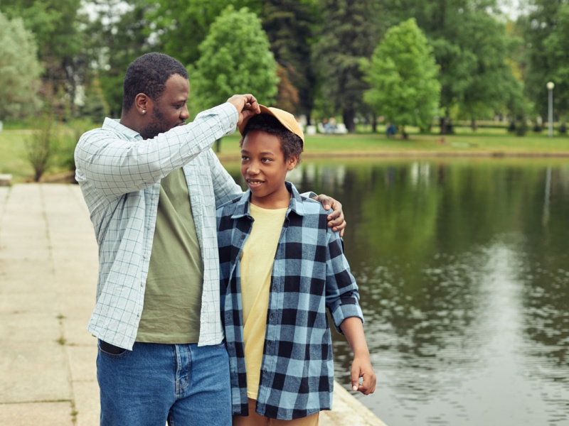 Dad and son enjoy summer by the lake