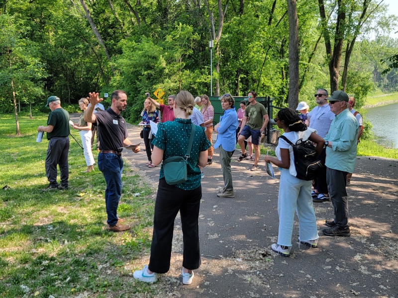 Group gathers at water's edge to listen to guide