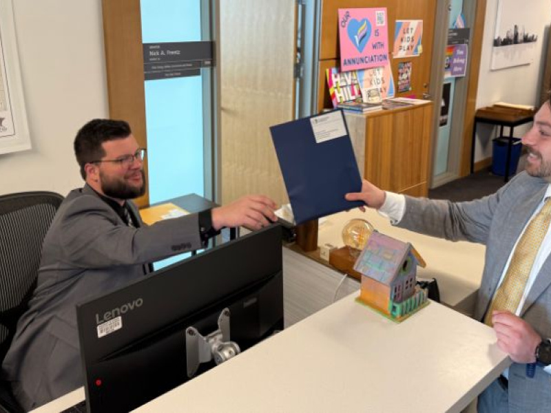 Conservation Minnesota's James Lehner delivers constituent postcards to Travis Urness, Legislative Assistant to Senate Assistant Majority Leader Nick Frentz
